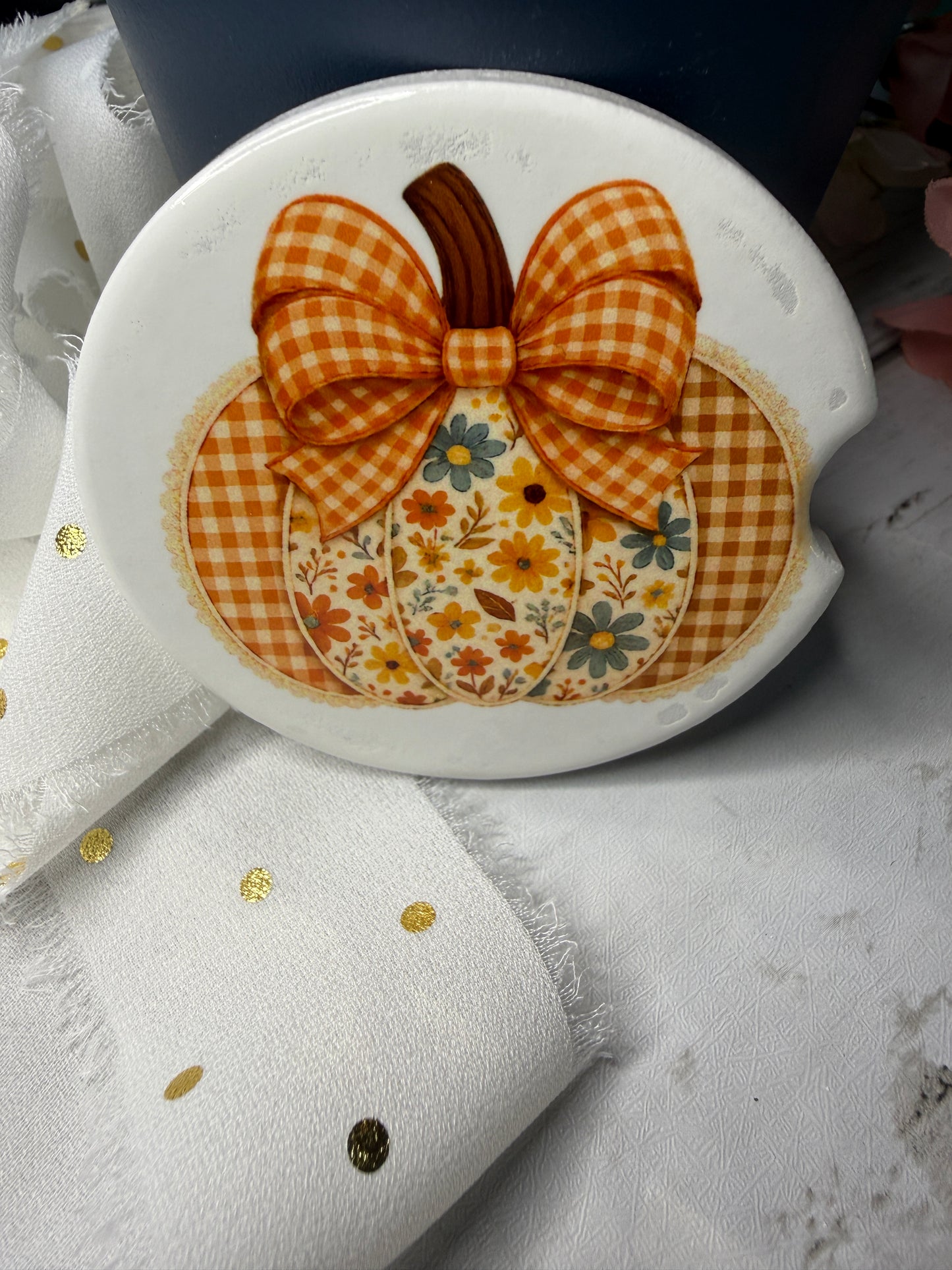 Car Coaster with a checkered bow and floral design on a white background